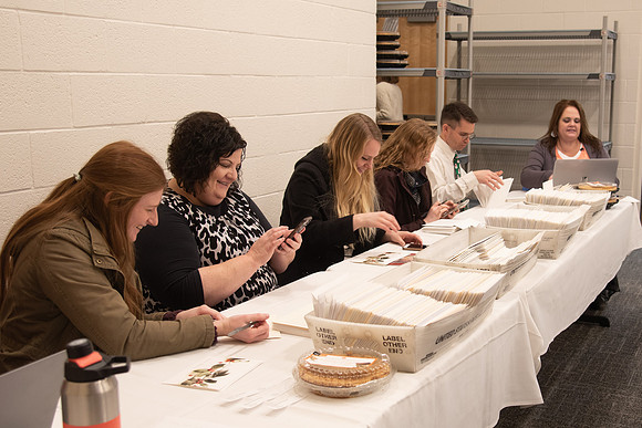 People sorting the cards for employees at the Employee Christmas Pie Social.