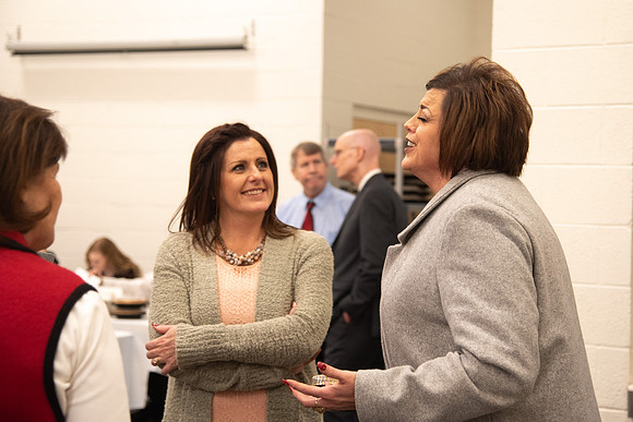Employees socializing at the Employee Christmas Pie Social.