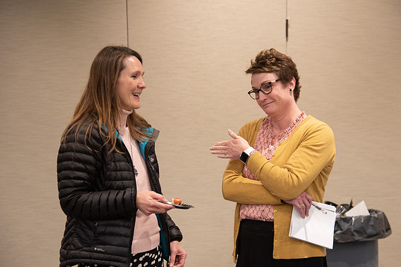 Employees socializing at the Employee Christmas Pie Social.