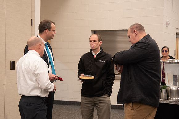 Employees socializing at the Employee Christmas Pie Social.