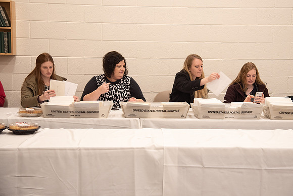 People sorting the cards for employees at the Employee Christmas Pie Social.