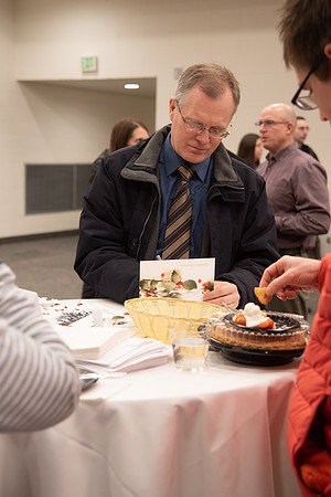 Employee writing a card at the Employee Christmas Pie Social.