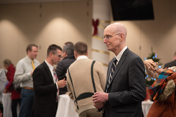 President Eyring listening to the brass band play Christmas music.