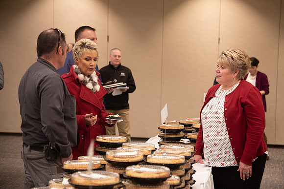 Employees come to get a pie from President Eyring and President's Executive Group.