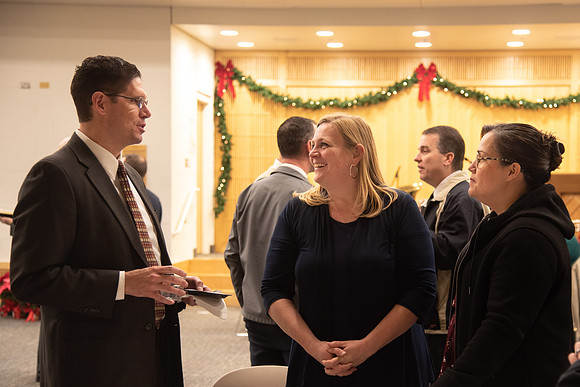 Employees socializing at the Employee Christmas Pie Social.