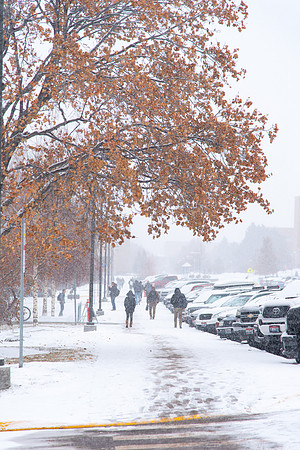Fresh snow falling on campus of BYU-Idaho. Students walking to class.