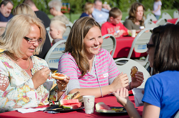 Online instructors gather with their families for an eveing of BBQ and games.