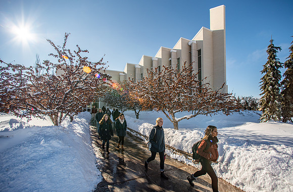 Students walking \on campus during a sunny winter day at the start of winter semester.