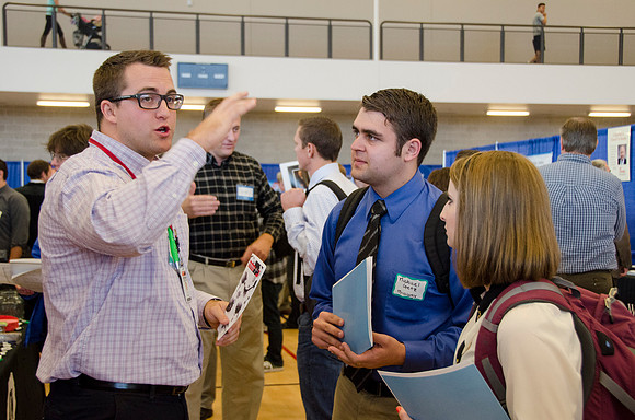 BYU-Idaho students speak to representatives from colleges or companies from their field of study at a career fair held in the I-Center gym
