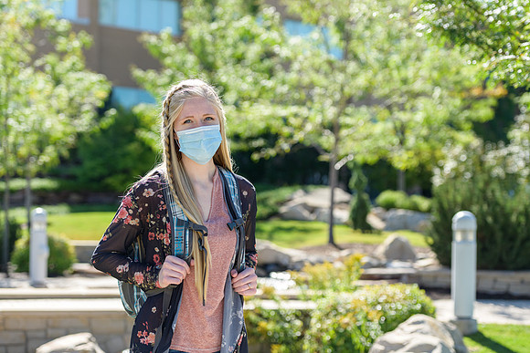 Student volunteers show the way to stay safe during this COVID 19 pandemic by social distancing, following pathway arrows and proper wearing of masks .
