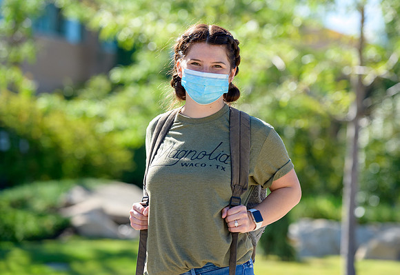 Student volunteers show the way to stay safe during this COVID 19 pandemic by social distancing, following pathway arrows and proper wearing of masks .