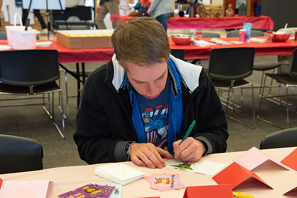 Students decorate sugar cookies and valentine cards in the MC on Valentine's Day.