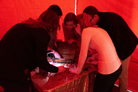 A few students participate in a valentines day themed escape room.