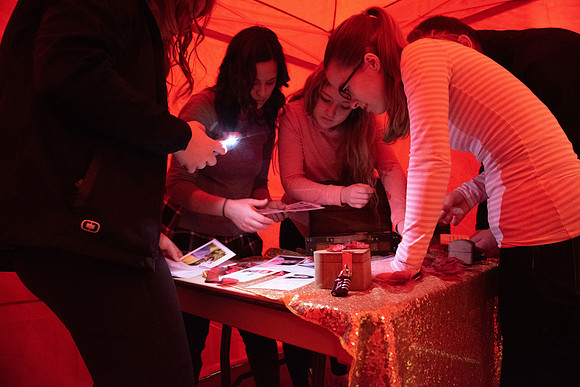 A few students participate in a valentines day themed escape room.
