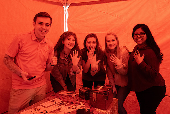 A few students participate in a valentines day themed escape room.