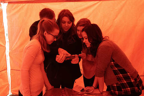 A few students participate in a valentines day themed escape room.