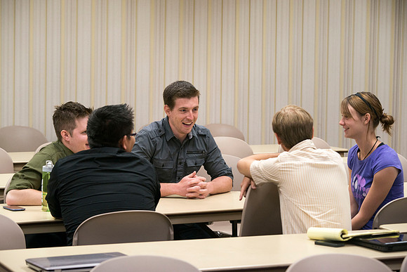Political Science students in Brother Adamson's class interact with each other as they participate in a hands-on activity during class.