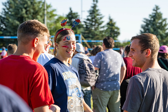 Students gather at the upper field for various 4th of July activities.
