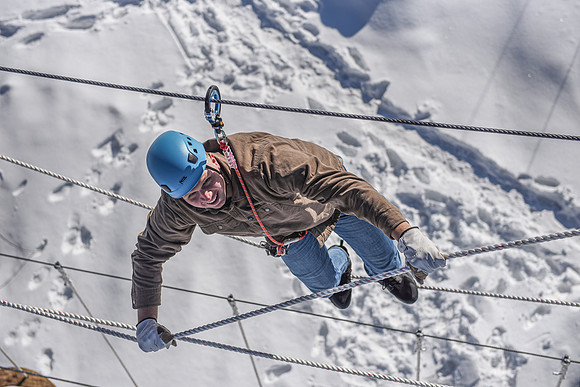 Students explore the new ropes course which includes multiple suspended obstacles as well as a ziplines course.