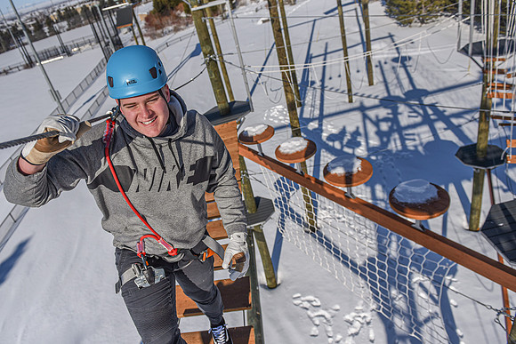 Students explore the new ropes course which includes multiple suspended obstacles as well as a ziplines course.