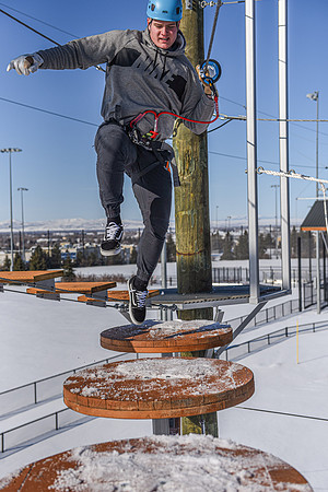 Students explore the new ropes course which includes multiple suspended obstacles as well as a ziplines course.