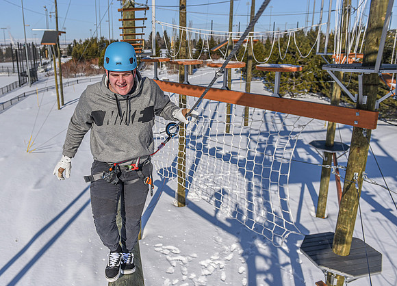 Students explore the new ropes course which includes multiple suspended obstacles as well as a ziplines course.
