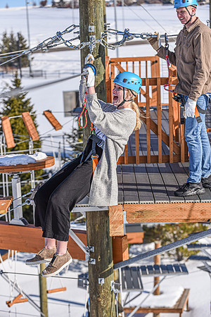Students explore the new ropes course which includes multiple suspended obstacles as well as a ziplines course.