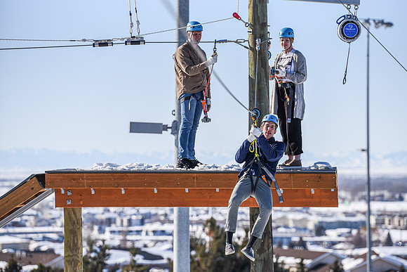 Students explore the new ropes course which includes multiple suspended obstacles as well as a ziplines course.