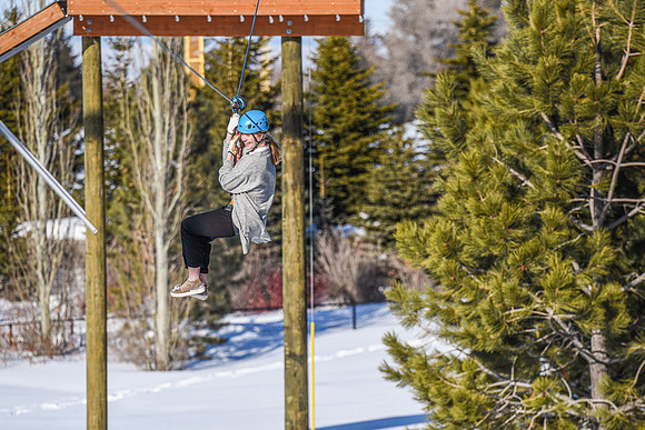 Students explore the new ropes course which includes multiple suspended obstacles as well as a ziplines course.