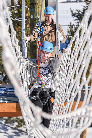 Students explore the new ropes course which includes multiple suspended obstacles as well as a ziplines course.