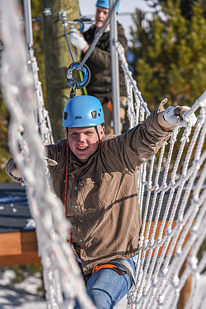 Students explore the new ropes course which includes multiple suspended obstacles as well as a ziplines course.