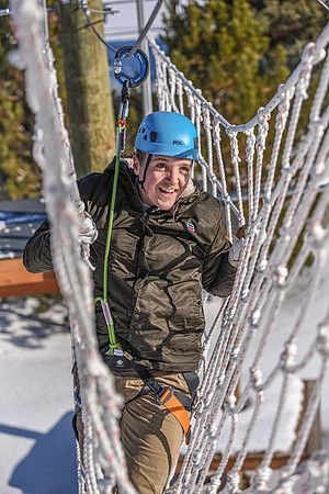 Students explore the new ropes course which includes multiple suspended obstacles as well as a ziplines course.