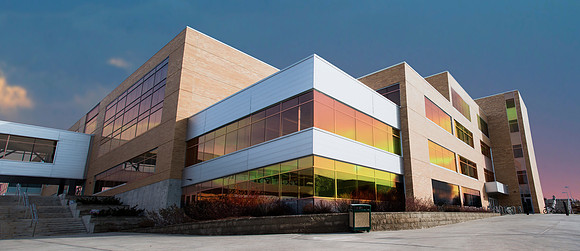Composite photo of the sunset and the Manwaring Center.