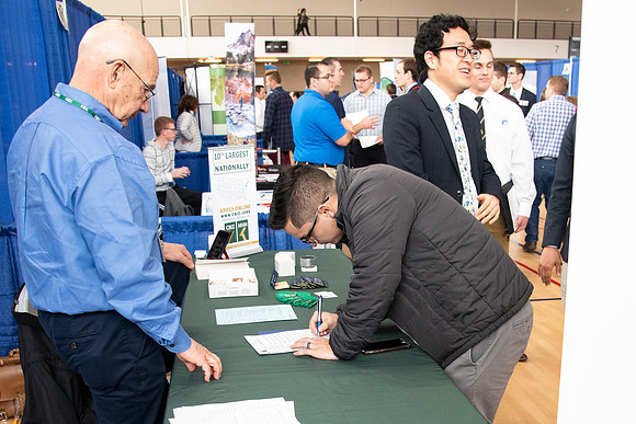 Students meet with different businesses for potential internships and jobs at a career fair at BYU-Idaho.