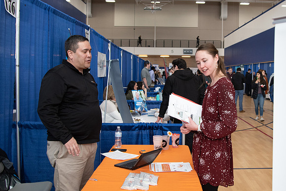 Students meet with different businesses for potential internships and jobs at a career fair at BYU-Idaho.
