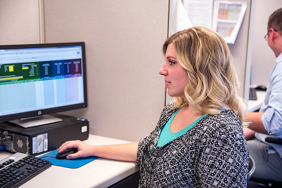 Employees work on developing a better curriculum for online students.
