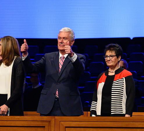 Elder and Sister Uchtdorg wave and welcome thousands of students to the devotional.
