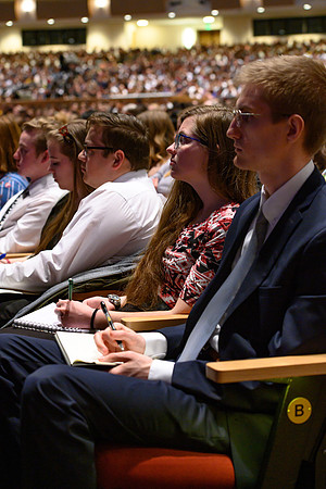 Students taking notes during devotional. Elder Uchtdorf, of the Quorum of the Twelve Apostles, and his wife Sister Uchtdorf speak at BYU-Idaho.