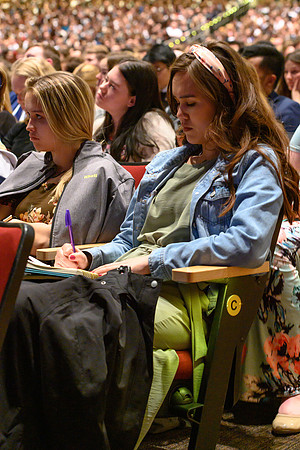 Young Women taking notes during devotional. Elder Uchtdorf, of the Quorum of the Twelve Apostles, and his wife Sister Uchtdorf speak at BYU-Idaho.