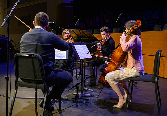 Students perform a musical number before Elder and sister Uchtdorf speak at devotional in the BYU-Idaho Center.