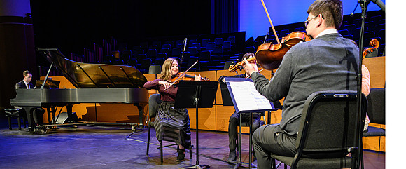 Students perform a musical number before Elder and sister Uchtdorf speak at devotional in the BYU-Idaho Center.