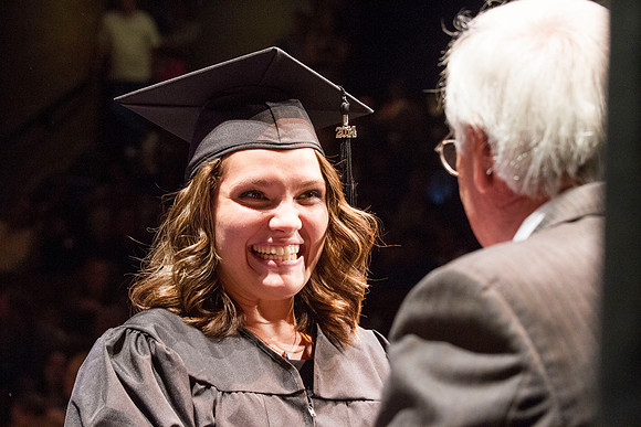Dean's of the College of Performing and Visual Arts award diplomas to graduates during convocation held in the Snow Building. Photo by Tyler Rickenbach