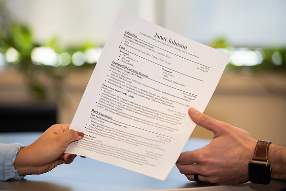 BYU-Idaho Career Center. Student handing out her resume. (photo illustration)