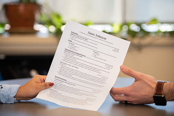 BYU-Idaho Career Center. Student handing out her resume. (photo illustration)