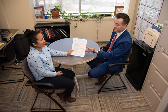 BYU-Idaho Career Center. Student handing out her resume. (photo illustration)