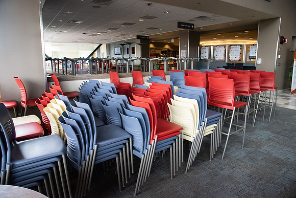The Crossroads is practically empty with the COVID-19 pandemic. Tables and chairs stacked up as other tables are separated to be six feet apart.