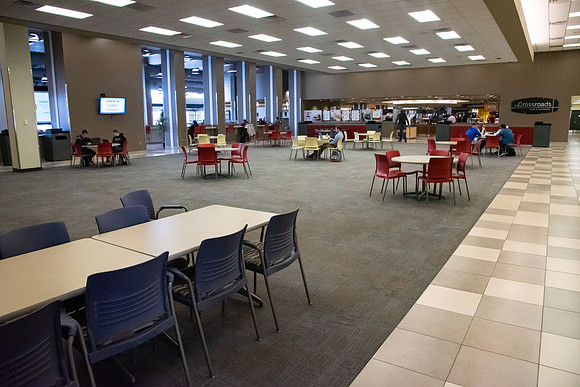 The Crossroads is practically empty with the COVID-19 pandemic. Tables and chairs stacked up as other tables are separated to be six feet apart.