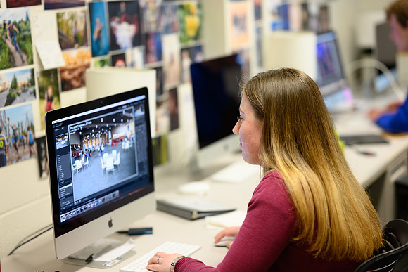 Brooke Larson busily editing photos from a recent photo assignment.