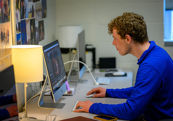 Lawson Turcotte busily editing photos from a recent photo assignment.