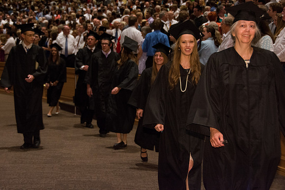 BYU-Idaho graduates walk in to the commencement ceremony, held in the BYU-Idaho Center.